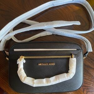 Never been used. Jet Set Large Saffiano Leather Crossbody Bag.